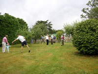People playing croquet on the back lawn