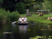 A man and a woman in a coracle on the lake